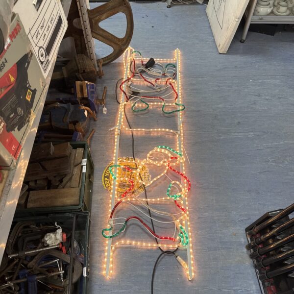 Large Santa climbing ladder light display for Christmas.