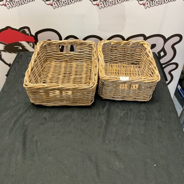 Two chunky wicker baskets for storage and rustic home decor.
