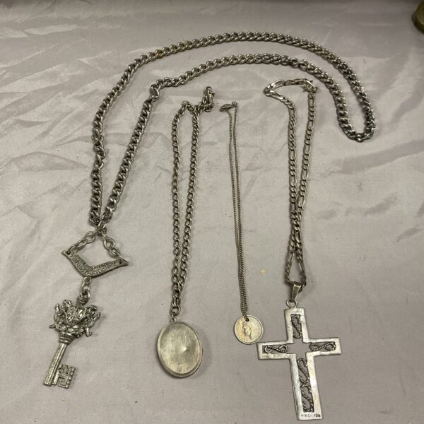 Silver crucifix necklace in a lot of vintage pendants.