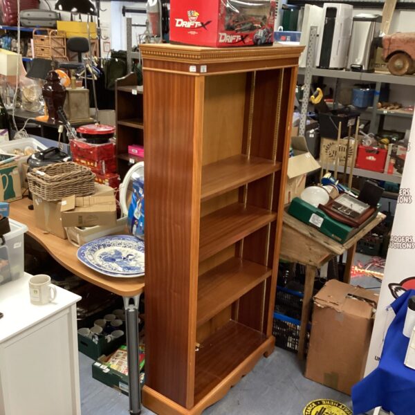 Vintage tall wooden cupboard with shelves for storage.