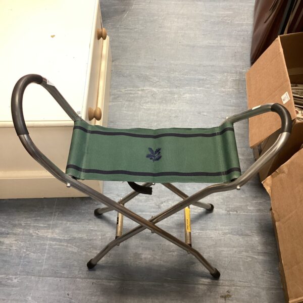 Vintage Cheltenham folding carry stool with green canvas seat.