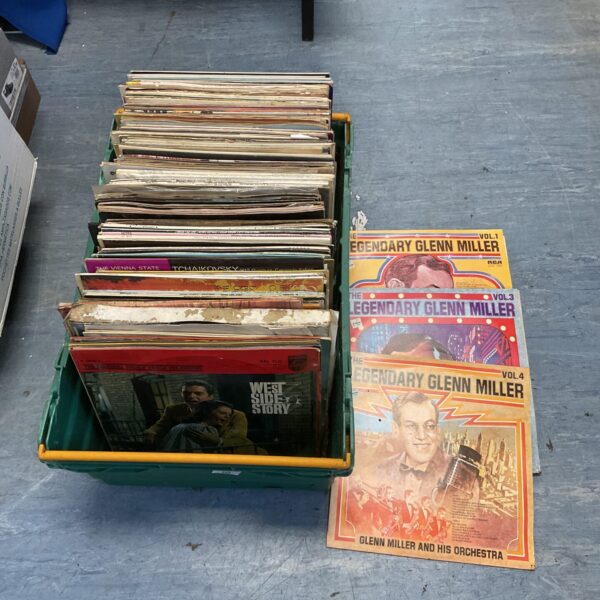 Crate filled with a large lot of vintage vinyl records.