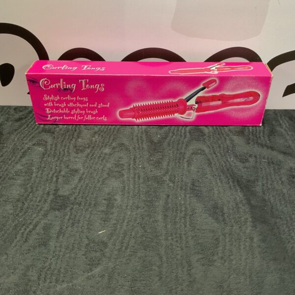 Vintage pink curling tongs for retro hair styling.