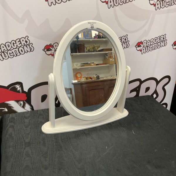 White oval dressing table mirror for vanity use.
