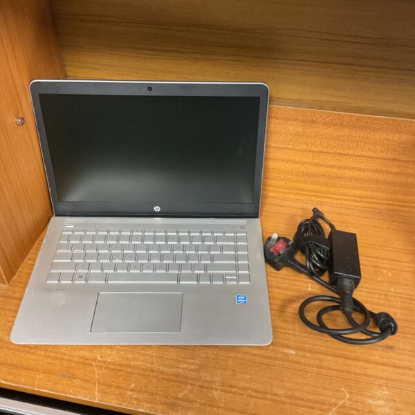 Silver HP Pavilion laptop with charger, ideal for collectors.
