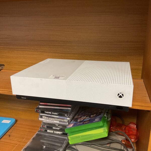 Front view of a Microsoft Xbox One S gaming console with games.
