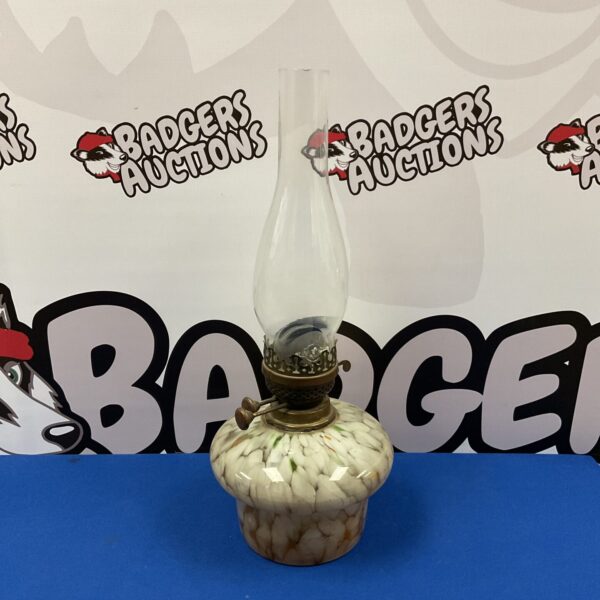 Vintage oil lamp with patterned glass body, antique collectible.