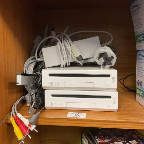 Two Nintendo Wii consoles with cables for retro gaming.