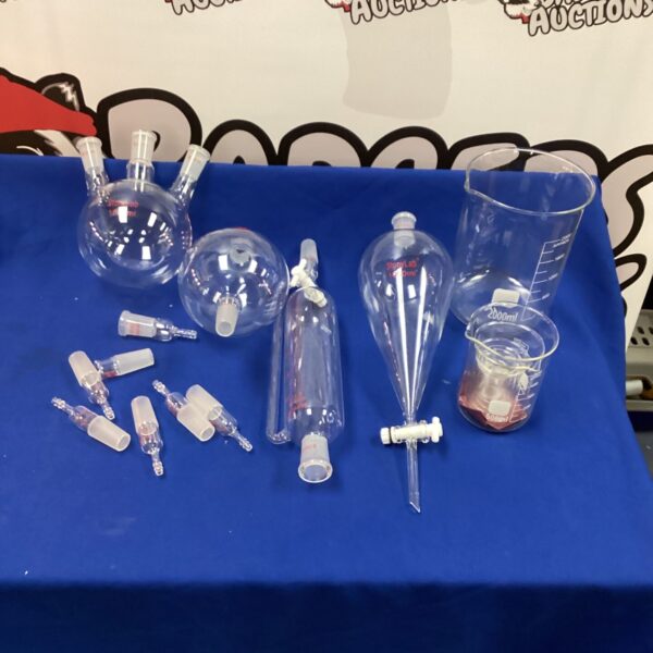 Vintage chemistry glassware set including beakers and flasks.