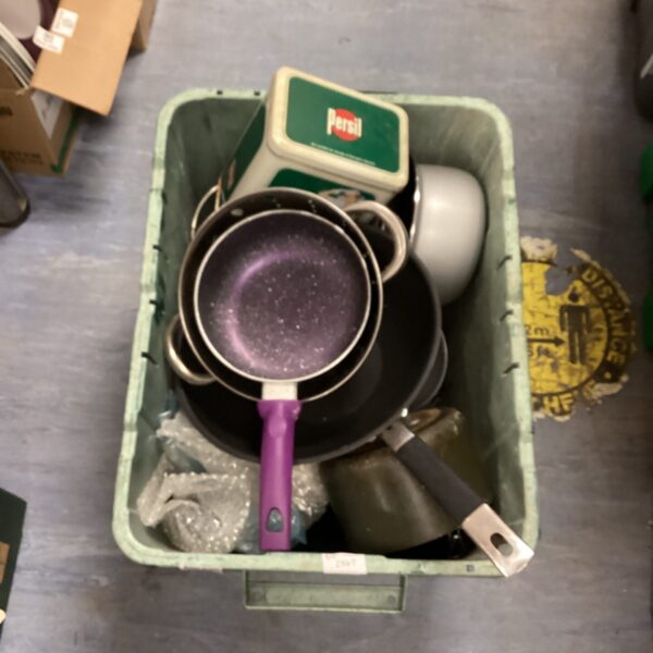 Collection of stainless steel kitchen pans with purple handle.