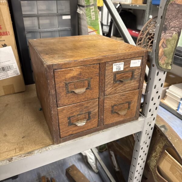 Vintage wooden filing unit with four drawers for office storage.