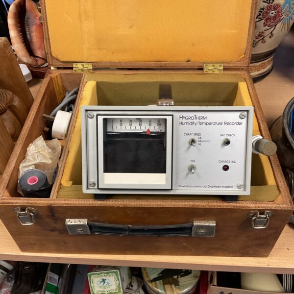 Vintage hygrotherm recorder in wooden case, showing dials.