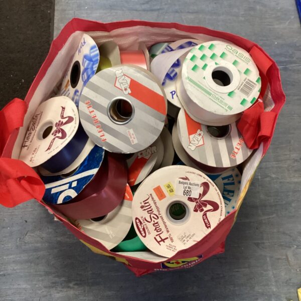 Large lot of white ribbon reels for crafting and event decoration.