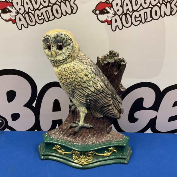 Antique cast iron owl doorstop with dark patina.