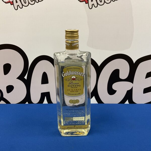 Sealed bottle of Danziger Goldwasser liqueur with visible gold flakes.