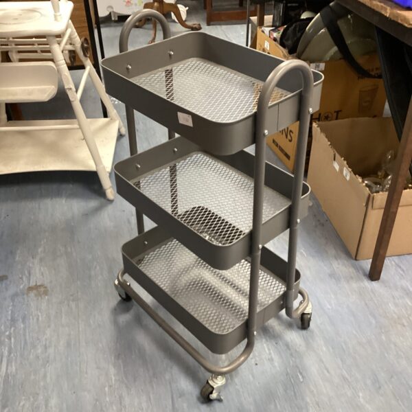 Three-tiered metal trolley with mesh baskets and casters.