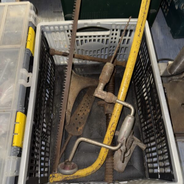 Vintage pipe wrench set with adjustable jaws and curved handles.