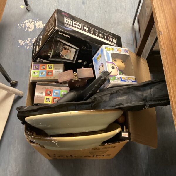 House clearance lot with barometer, Funko Pop, and electronic frame.