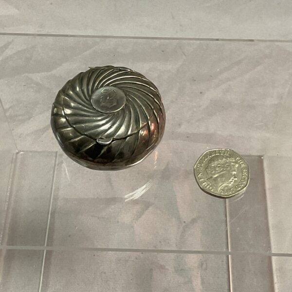 Antique Chester silver pill box with fluted design.