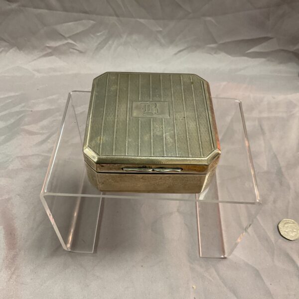 Hallmarked sterling silver cigarette box with ribbed lid.