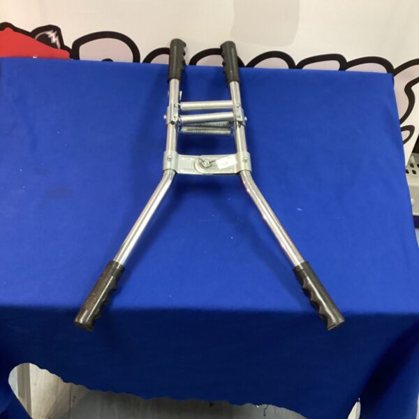 Vintage chest expander with wooden handles and spring mechanism.