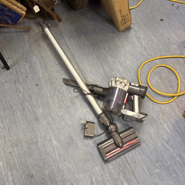 Front view of a grey Dyson V6 cordless vacuum cleaner.