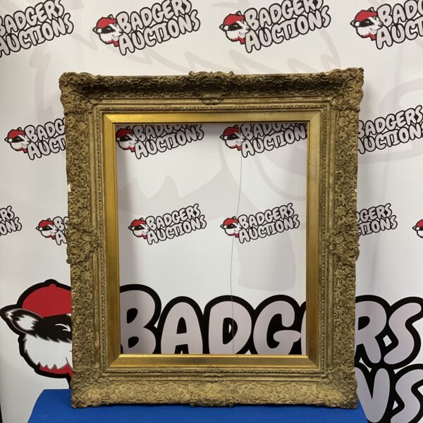 Ornate antique gilt picture frame with intricate carvings.