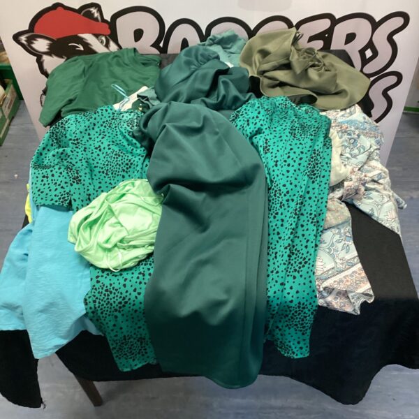 Ladies tops and a green evening dress in a fashion lot.