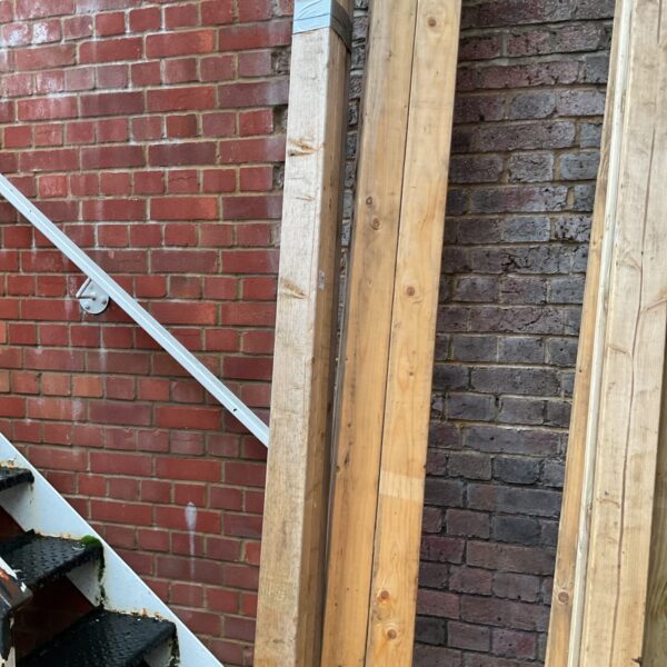 Outdoor timber bundles of 8ft and 9ft lengths for construction projects.