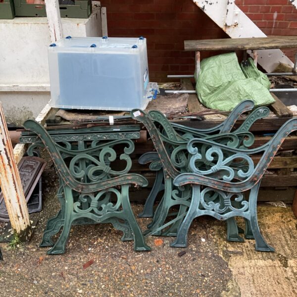 Antique cast iron garden bench ends with floral details.