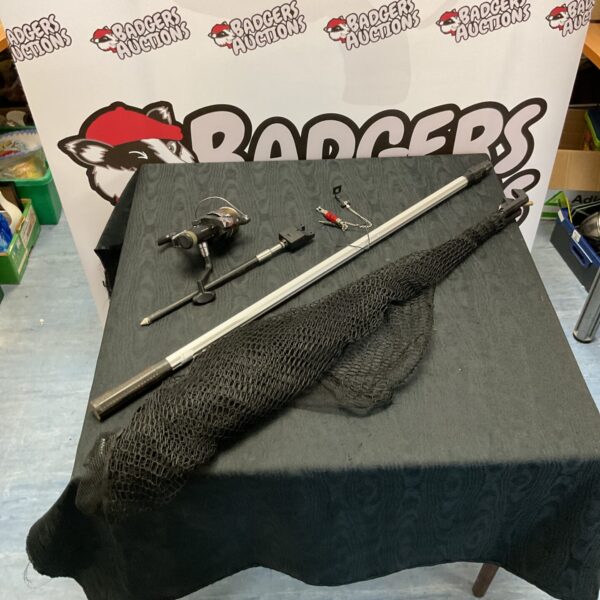 Carp fishing tackle bundle including reel, alarm, and landing net.