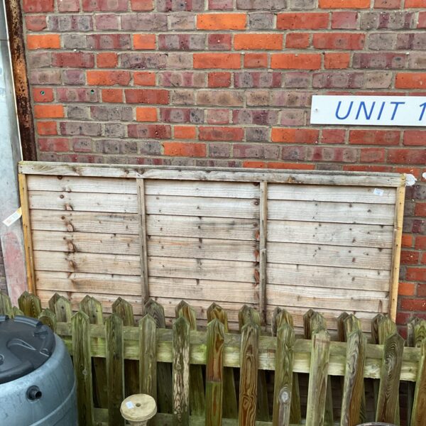Weathered wooden garden fence panel for outdoor privacy.