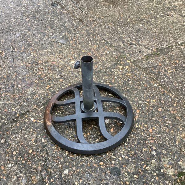 Vintage metal parasol stand for garden or patio use.