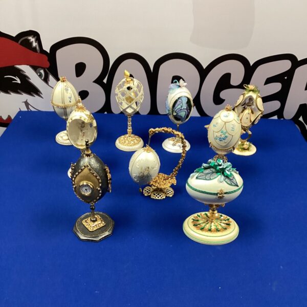 Ornate Faberge style egg on a stand, detailed porcelain and metalwork.