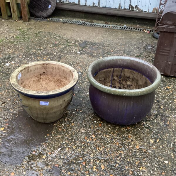 Vibrant purple glazed ceramic garden planter for outdoor plants.