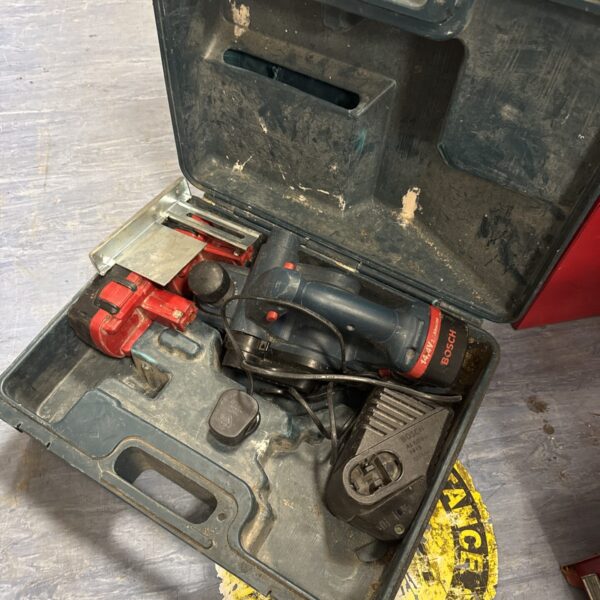 Bosch cordless planer in open carry case, showing the tool and accessories.