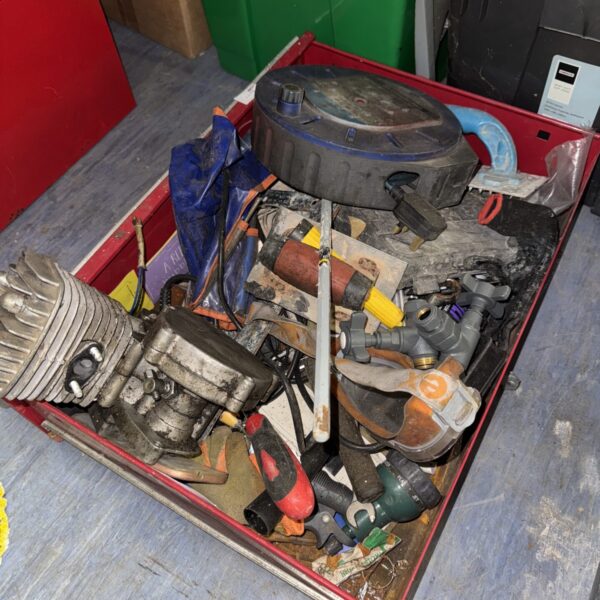 Mixed lot of small engine parts and tools for repair projects.