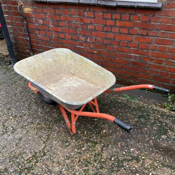 Heavy duty builders wheelbarrow with steel frame and pan.