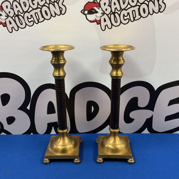 Vintage brass candlesticks with leather detailing, a decorative pair.
