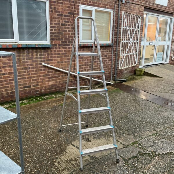 Silver Beldray 6-run stepladder against a brick wall.