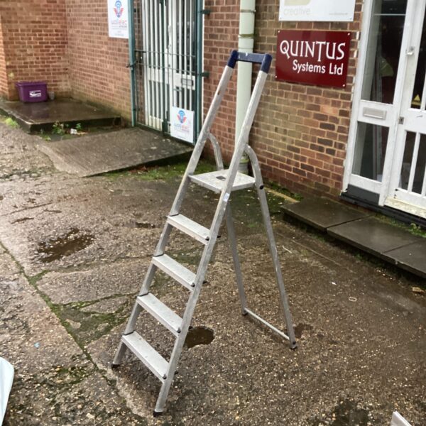 Silver aluminium step ladder with three steps, side view.