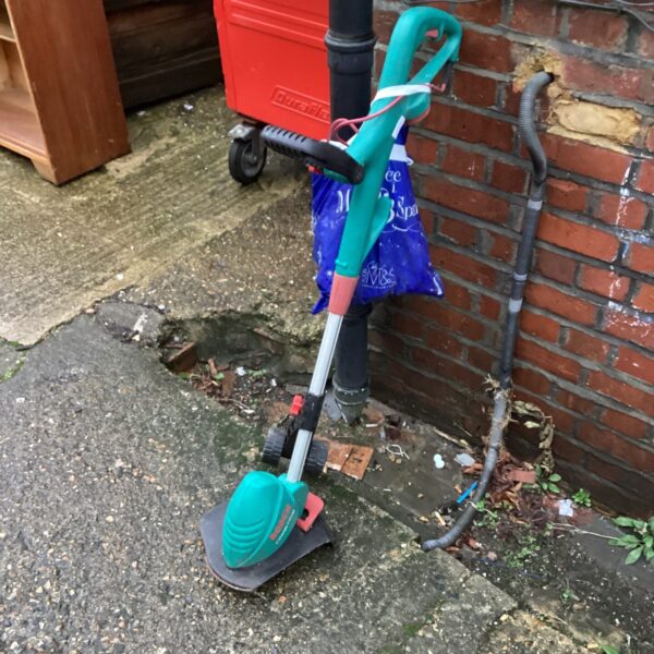 Bosch garden strimmer presented for auction, showing signs of use.