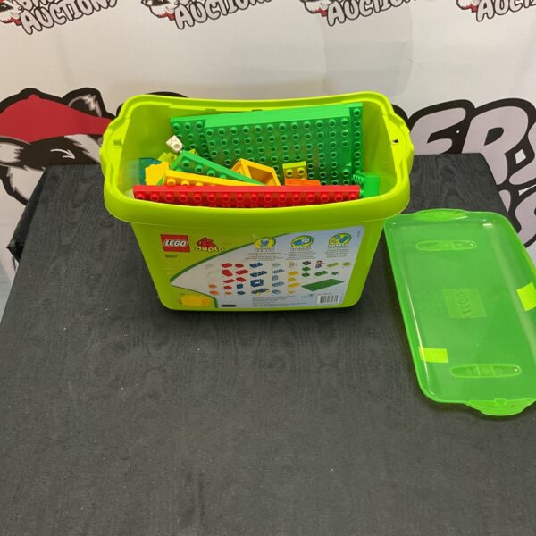 Large green box filled with colourful Lego Duplo building bricks.