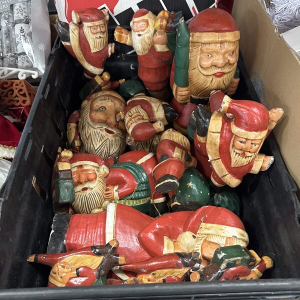 Tray of vintage carved wooden gnomes for Christmas decor.