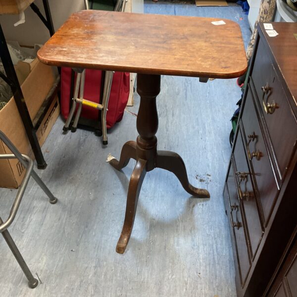 Antique mahogany tripod table with carved legs.