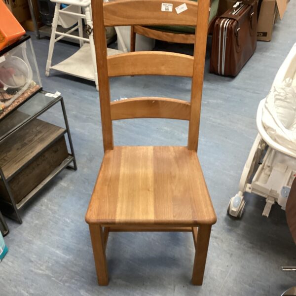 Vintage mahogany chair with curved backrest and shaped seat.