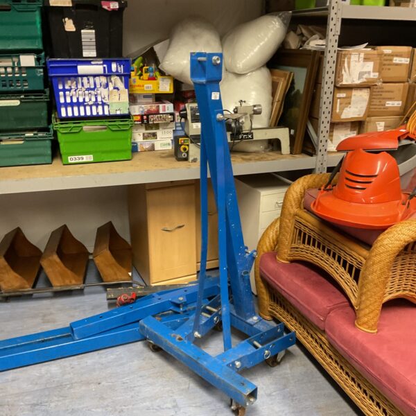 Blue engine crane in a workshop setting, ideal for auto repair.