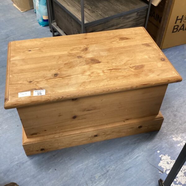 Vintage pine chest with lift-top lid for rustic storage.