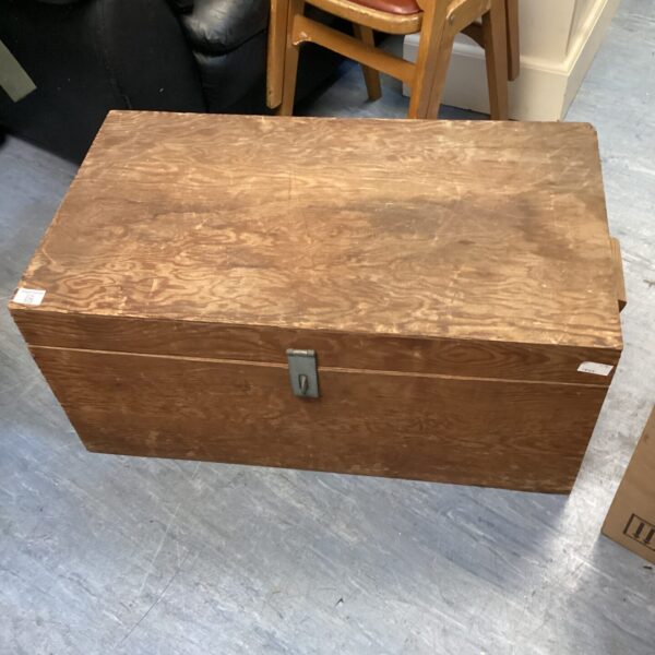 Front view of a large, vintage wooden chest.