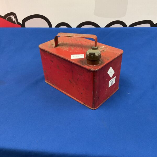 Vintage red petrol can, a collectible metal fuel container.